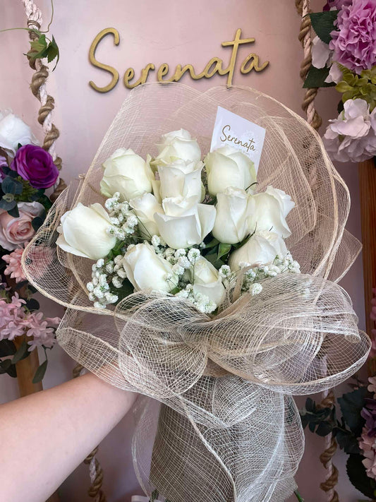 white roses in rustic wrapping